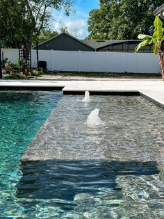 an outdoor pool with water flowing from it