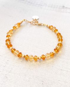 The stunning combination of sunny yellow and rich amber citrine creates a beautiful gemstone bracelet. This elegant piece is finished with luminous 14k gold-filled components. November's birthstone is nothing less than captivating. Bracelet length: 7.25 inches plus 1-inch extender Materials: 4-6 mm citrine faceted beads, 14 k gold-filled components Elegant Orange Beaded Bracelet With Natural Stones, Elegant Amber Beaded Bracelets With Natural Stones, Gold Jewelry With Citrine Gemstone Beads, Adjustable Yellow Gold Citrine Jewelry, Elegant Orange Beaded Bracelets With Gemstones, Amber Citrine Beaded Bracelets As A Gift, Amber Citrine Beaded Bracelet As A Gift, Adjustable Citrine Jewelry, Elegant Amber Beaded Bracelet With Gemstones