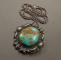 See More Vintage Native American Jewelry here: https://www.etsy.com/shop/YearsAfter?section_id=13095973 Sale! Orig $775 A Spectacular Vintage Native American Navajo Turquoise Necklace Pendant Brooch handmade by Legendary Navajo Artist Kirk Smith (1957-2012) in Sterling Silver with a Thick Gorgeous Slab of Natural Pilot Mountain Turquoise in a Green Blue Color with a Chocolate Brown Matrix on 22" Vintage Sterling Rope Chain, All Tested and Guaranteed Sterling, Early KS Sterling Hallmark, Shepard's Hook Hidden Bale, Safety Closure, Weighty 52.7 Grams circa 1970 to 1980's!  Approx. Measurements: Pendant is 2-1/4" in length by 2-1/8" wide. Turquoise is 1-5/16" in length. Sterling Chain is over 22" in length. Unisex for both Men and Women! This Magnificent Pendant is a Rare Early Beauty! The Pi Southwestern Engraved Turquoise Necklace, Engraved Southwestern Turquoise Necklace, Turquoise Concho Necklace As Gift, Southwestern Style Engraved Turquoise Necklaces, Blue Turquoise Concho Necklace As A Gift, Southwestern Untreated Turquoise Necklace, Untreated Western Style Jewelry For Gifts, Untreated Southwestern Turquoise Necklace, Western Turquoise Jewelry With Patina