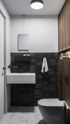 a modern bathroom with black and white tiles