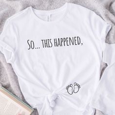 New baby on the way? What a fun way to announce your pregnancy with this pregnancy announcement shirt❤️ 🧵- This is a classic unisex jersey short sleeve tee, It's made from 45% recycled polyester and 55% organic cotton made to order specially for you! Athletic Heather has a different composition of 90% organic cotton and 10% recycled polyester. This t-shirt has a modern semi-relaxed fit with a trendy high neckline.   🫧 - Care and wash instructions: Machine wash: cold (max 30C or 90F); Non-chlor Maternity Graphic Tee With Short Sleeve, Maternity T-shirt With Funny Text, Maternity T-shirt With Funny Text And Short Sleeves, Maternity Short Sleeve T-shirt With Funny Text, White T-shirt With Funny Print For Gender Reveal, Maternity Cotton T-shirt With Funny Text, Family Matching White Maternity T-shirt, White Family Matching Maternity T-shirt, Maternity Summer T-shirt Crew Neck