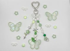 some green and white charms on a white surface