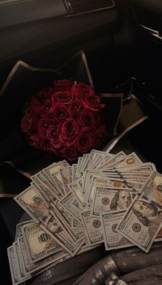 roses and money are sitting in the back seat of a car