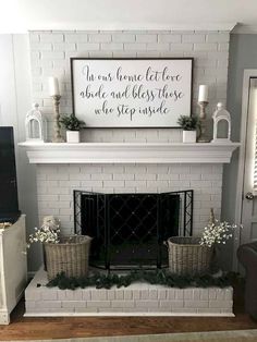 a white brick fireplace with some baskets on the mantel and a sign above it