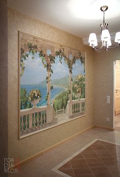 an empty room with a painting on the wall and chandelier hanging from the ceiling