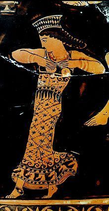 an ancient greek vase with a woman dancing