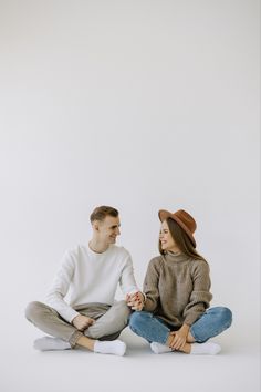 a man and woman sitting on the floor together