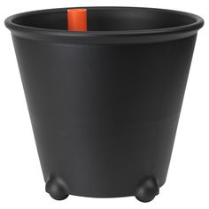 a black pot with an orange handle on the top and wheels for handles to hold items