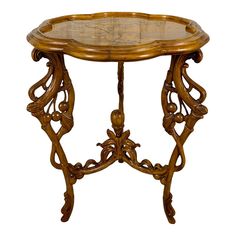 an ornate wooden table with glass top