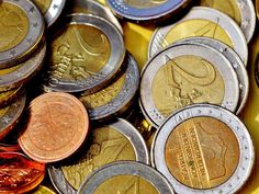 a pile of different colored coins sitting on top of each other