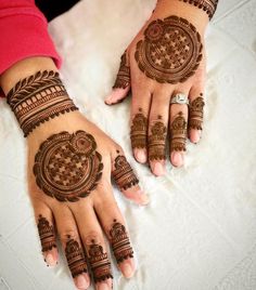 two hands with henna designs on them