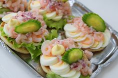 small appetizers with shrimp and cucumbers in them on tin foil tray