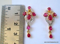 14k GOLD EARRINGS EAR STUD FROM RAJASTHAN INDIA, GREAT HANDMADE DESIGN MADE OF 14K YELLOW GOLD SATED REAL A QUALITY RUBY & DIAMOND GEM STONES, NICE PIECE GOOD FOR JEWELRY COLLECTION.Height max. - 2.8 cm(1.1")width max. - 1.2 cm(0.47")Total weight - 3 gramsMaterial - 14 carat solid yellow gold & real gem stones. Traditional 17 Jewel Diamond Earrings For Anniversary, Yellow Gold Ruby Earrings With Diamond Accents, Gold Ruby Earrings With Diamond Accents, Gold Earrings With Gemstone And American Diamond, Traditional Red Diamond Earrings, Ruby Earrings For Anniversary And Festive Occasions, Festive Ruby Earrings For Anniversary, Earrings Diamond, Earrings Ear