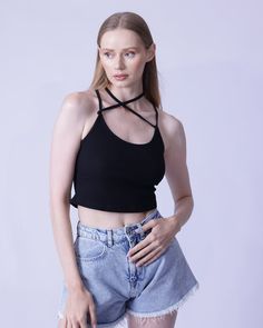 Show off your figure in this sophisticated yet sultry rib-knit cami top, complete with dainty spaghetti straps, a teasingly cropped length, and a slim-fitting silhouette. Adorned with chic cross-striped detailing, this top is crafted of a high-stretch fabric composed of 97% cotton and 3% spandex for all-day comfort. To keep your look fresh, we recommend machine washing or professional dry cleaning. Spring Crop Top With Built-in Bra For Night Out, Ribbed Camisole Crop Top, Spaghetti Strap Crop Top For Night Out, Chic Seamless Crop Top For Spring, Trendy Bra-friendly Cami Crop Top, Trendy Spaghetti Strap Crop Top For Night Out, Trendy Spaghetti Straps Crop Top For Night Out, Trendy Strappy Halter Top With Crisscross Straps, Chic Cropped Tank Top With Built-in Bra