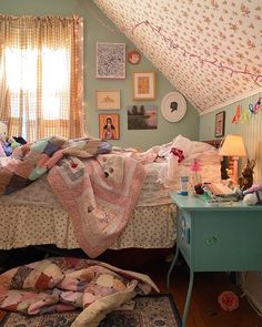 a room with a bed, desk and pictures on the wall above it that have been decorated in pastel colors