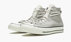 The Fear of God x Converse Chuck 70 “Grey” is Jerry Lorenzo’s remaking of the iconic high-top shoe for Fear of God��’s “Essentials” sub-label for Winter 2019.  Inspired by the necessities of the modern wardrobe, Fear of God’s Chuck 70 is an easy-wearing, versatile footwear option for those seeking an alternative to the classic Chuck 70.  The upper sports durable light grey canvas that is contrasted by a cream leather tongue.  Functional upgrades include an extended lace loop on the heel, which giv Fear Of God Shoes, Jerry Lorenzo, Converse Hi, White High Tops, Converse Chuck 70, Sneakers Addict, Stadium Goods, Chuck 70, Converse Sneakers