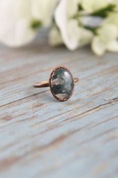 Your natural gemstone artisan ring collection is not complete without a large crystal, moss agate ring. Handmade with healing crystals and natural stones, this copper jewelry awakens the wild woman. The moss agate jewelry is made with electroformed copper, making each piece unique and one of a kind, just like you. Embrace your intuitive nature and click through to see more gemstone jewelry! Handmade Oval Moss Agate Ring, Moss Agate Rings, Ring Moss Agate, Oval Stone Ring, Agate Rings, Moss Agate Jewelry, Jewelry Wax, Raw Gemstone Jewelry, Green Moss Agate