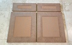 four pieces of cardboard sitting on top of a tile floor