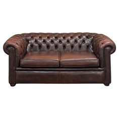 a brown leather couch sitting on top of a white floor