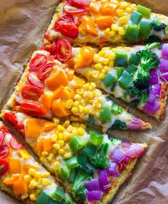 a pizza with many different toppings on it sitting on top of a piece of parchment paper