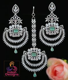 Beautiful Rhodium plated American Diamond stone studded Mughal style Earrings and maang tikka set. The design is a combination of chandbali and floral motif embellished with teardrop and marquise cut Cz Mint Green stones. The length of the earrings is 3.75 and the width is 1.75 inches Punjabi Earrings, Maang Tikka Set, Indian Designs, Wedding Indian, Maang Tikka, Green Stones, Color Stones, Cz Jewelry, Stone Studs