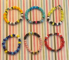 four bracelets are arranged on a striped surface