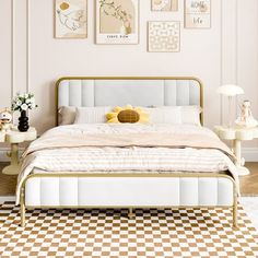 a bedroom with pink walls and checkered flooring is pictured in this image, there are pictures on the wall above the bed