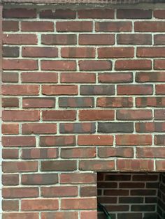 a fire hydrant sitting next to a brick wall