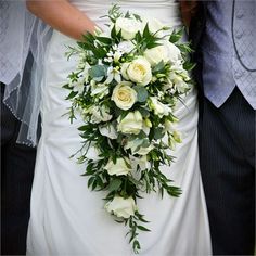 the bride and groom are holding their bouquet