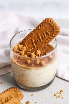 a cookie in a glass with some peanut butter on top