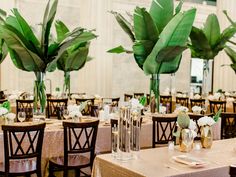 the tables are set up with vases and flowers