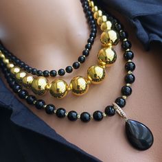 Meet our stunning Gold and Onyx MultiStrand Beaded Necklace, a true statement piece that exudes elegance and sophistication. Meticulously handcrafted, this necklace consists of multiple strings of shiny gold and onyx beads, meticulously assembled to create a stunning visual effect. Shiny black onyx beads, known for their grounding and protective properties, add a mystical touch to this elegant accessory. MATERIALS: Your necklace is created using high quality gold filling and black onyx beads, kn Gold Single Strand Beaded Necklace For Party, Elegant Gold Beaded Necklaces With Gemstone, Elegant Gold Beaded Necklace With Gemstones, Elegant Beaded Necklaces For Party, Elegant Party Necklaces With Round Beads, Evening Beaded Necklaces With Polished Round Beads, Elegant Gemstone Beads Jewelry For Party, Round Polished Beads Necklace For Party, Party Necklace With Round Polished Beads