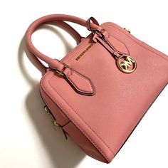 Beautiful $300 Michael Kors Ayden Dome Medium Satchel Bag. (38H9CYVS2L) Saffiano leather Zip closure Interior 1 zip pocket, 1 slip pocket Gold hardware. Logo hang charm Removable and adjustable strap. Crossbody capabilities Approx. 10 w x 8 h x 5 d inches; 4" handle drop; 17.5-21.5" adjustable strap drop  Weight approx. 1.10 lb New and Original. Impeccable condition. Item comes from a smoke free home. Please ask any questions before bidding. Happy to answer all. Please note that I am not a retai Michael Kors Spring Bags, Michael Kors Bags For Spring, Michael Kors Spring Bags With Detachable Strap, Chic Pink Michael Kors Satchel, Drop Weight, Pocket Logo, Satchel Bag, Handbags Michael Kors, Types Of Fashion Styles