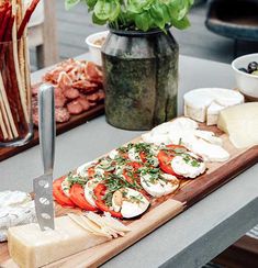 a wooden cutting board topped with lots of food