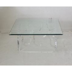 a glass coffee table with metal legs