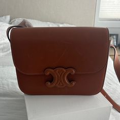 Brand New And Never Worn Authentic Celine Natural Calfskin Medium Triomphe In Tan. Features And Adjustable Strap Comes With Box And Dust Bag. Absolutely Stunning! No Longer Sell This With The Tan Closure Retails $4300 Luxury Brown Calf Leather Flap Bag, Designer Calf Leather Flap Bag, Classic Tan Calf Leather Shoulder Bag, Designer Tan Shoulder Bag, Designer Tan Shoulder Bag With Leather Lining, Designer Tan Flap Bag For Evening, Luxury Tan Flap Shoulder Bag, Designer Tan Calf Leather Shoulder Bag, Luxury Tan Crossbody Flap Bag