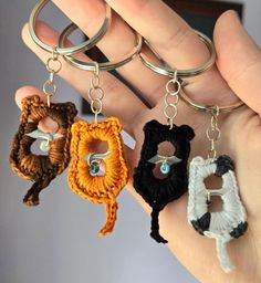 three crocheted keychains in the palm of someone's hand