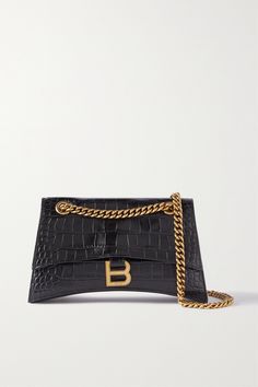 Balenciaga's 'Crush' shoulder bag is designed in a similar curved shape as the brand's iconic 'Hourglass' tote. It's made from black croc-effect leather and has a gold-tone 'B' logo that complements the chain strap, which you can double up for a shorter drop. The dual internal compartments and zipped pocket will keep your belongings organized. Balenciaga Crush Bag, Balenciaga Hourglass Bag, Black Balenciaga, Balenciaga Bag, Double Up, Black Cross Body Bag, Curator Style, Designer Bags, Clutch Handbag