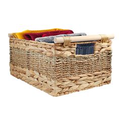 an empty basket with towels and blankets in it on a white background for use as a storage container