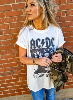 We're "livin' easy and lovin' free" with AC/DC! This vintage style rock tee is designed with black and white graphics from AC/DC's fifth studio album, "Highway To Hell". Made with soft cotton fabric, a ribbed crew neckline, short sleeves, and a classic oversized t-shirt fit. Black And White Graphics, Custom Trucker Hats, Highway To Hell, Vintage Soul, Rock Tees, Style Rock, Latest Instagram, Shoe Gifts, Pullover Jacket