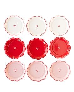 six red and white plates with hearts in the middle one has a heart on it