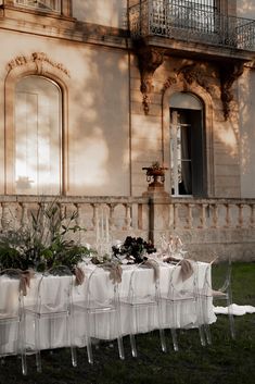 the table is set up outside in front of an old building