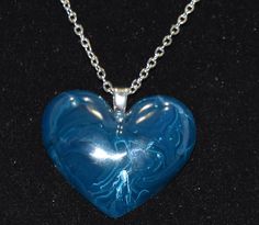 Blue Heart Necklace made in Resin with a White Swirl, Hear post for the pendant Silver tone metal Chain Ready to enhance any outfit. Blue Heart Beads Heart-shaped Necklace, Blue Heart Beads Heart Necklace, Blue Heart Beads Necklace In Heart Shape, Blue Heart Necklace For Valentine's Day Jewelry Making, Blue Heart Beads Necklace, Handmade Blue Heart Pendant Necklace, Heart Necklace Blue, Blue Heart Necklace, Blue Swirl