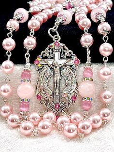 "Magnificent 8mm Rosaline Austrian crystal pearl rosary made with the finest quality satin smooth European pearls, crystals, 10mm Rose Quartz gemstones, Cat's Eye gemstones, and silver plated embellishments. This rosary is very dressy and formal, yet perfect for every Sacramental occasion, First Communion, Wedding, Confirmation, or that special gift that says, \"I'm thinking of you\". If you're wanting Swarovski pearls, I think you'll find the quality of these Rosaline pearls to match them in we Elegant Pink Rosary Bracelet For Wedding, Elegant Pink Wedding Rosary Bracelet, Wedding Rosary With Crucifix Spiritual Style, Spiritual Wedding Rosary With Crucifix, Spiritual Wedding Jewelry With 8mm Beads, Spiritual 8mm Beads Jewelry For Wedding, Pink 8mm Beads Jewelry For Wedding, Spiritual Beaded Rosary Bracelet For Wedding, Spiritual Crucifix Jewelry For Wedding