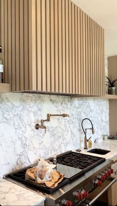 a stove top oven sitting inside of a kitchen next to a counter with an oven