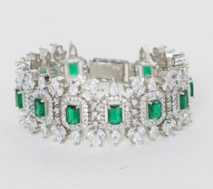 Featuring a white finish faux diamond bracelet with green stones. It is perfect for a cocktail party and can be paired with an indo western style for a cocktail. Dimensions (Inches) : 6 x 1 Composition : Faux Diamonds, Green Stones & Mixed Metal Care: Keep away from water and perfume Delivery : 6-8 weeks as the product is hand crafted. For more information and sizes please contact fabiliciousfashion@gmail.com or visit our Copenhagen studio. About the Designer : For brides-to-be and jewellery lov Green Rhinestone Bracelets For Wedding, Indian Theme, Indian Wedding Wear, Green Stones, Indo Western, Traditional Indian, Exquisite Jewelry, Mixed Metals, Green Stone