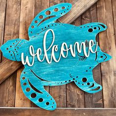 a wooden sign that says welcome with a sea turtle