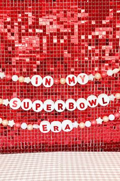 there is a red and white wall with words on it that say in my super bowl era