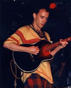 a man playing an electric guitar on stage