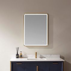 a bathroom vanity with a large mirror above it and a blue cabinet underneath the sink